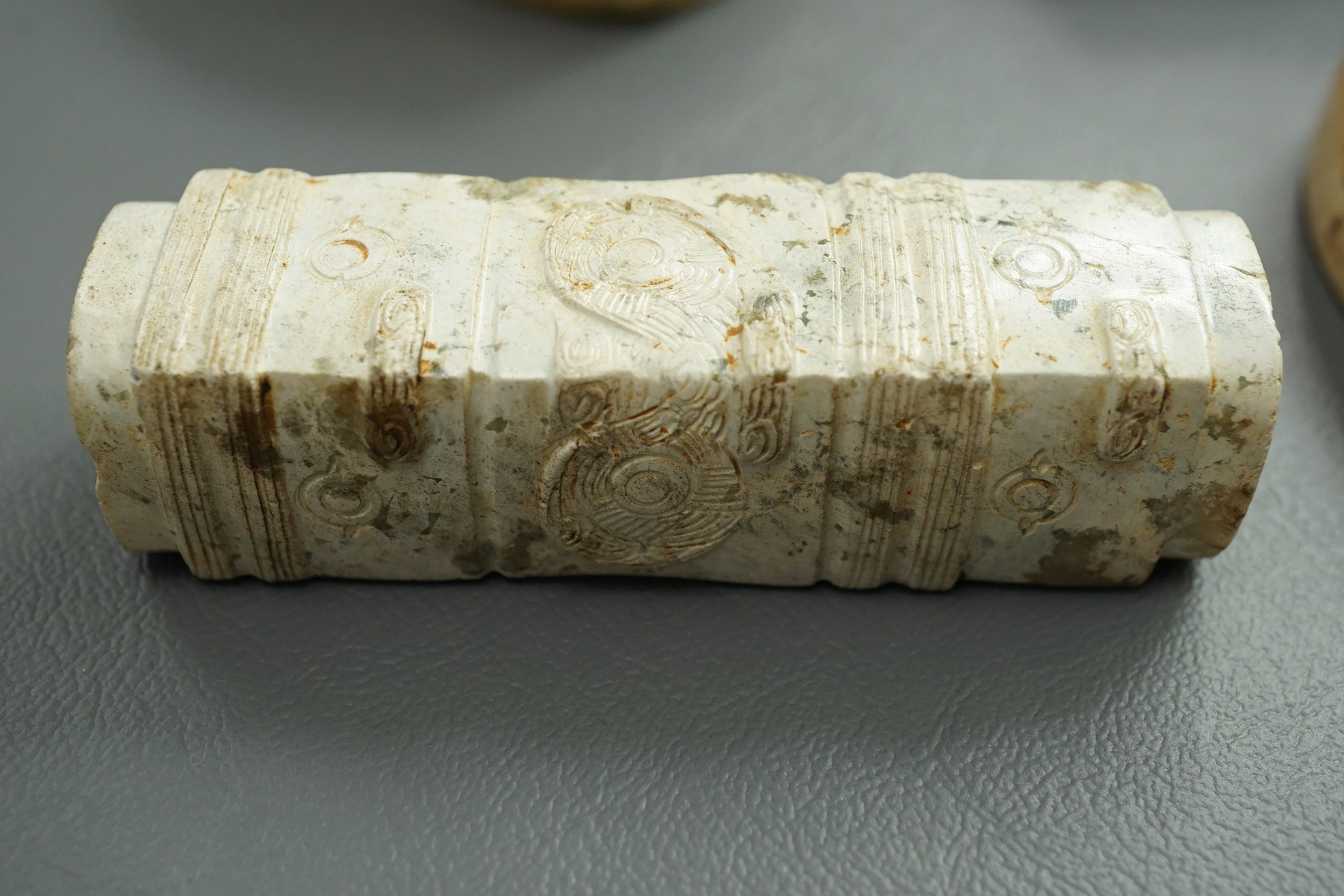 Four Chinese archaistic hardstone or burnt jade cong or cylinders